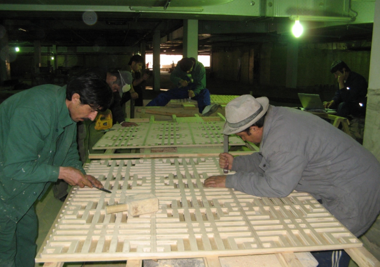 April 2009: Local craftsmen work on the latticed wood panels.