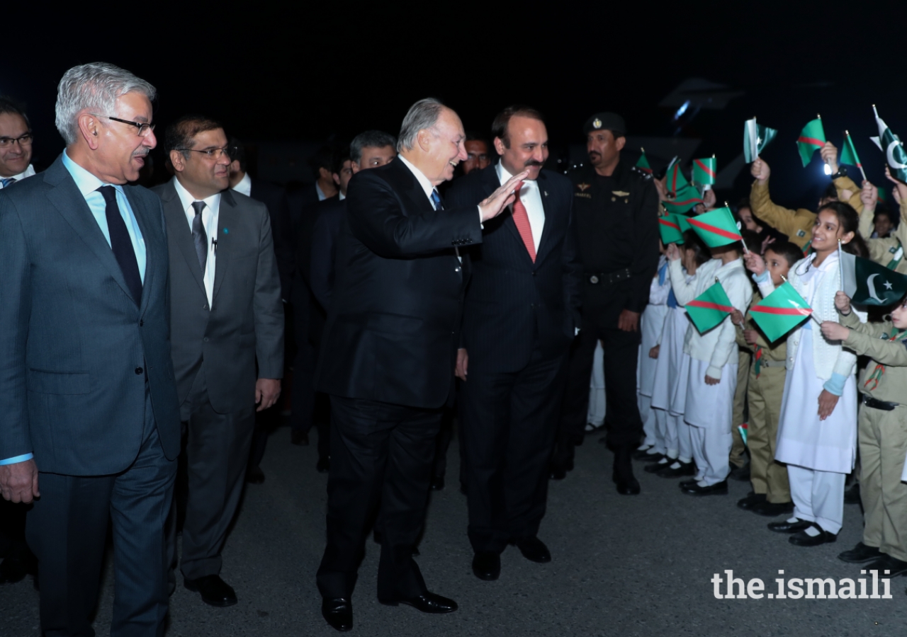 Mawlana Hazar Imam waving happily at the jubilant shaheen scouts and junior guides upon his arrival.