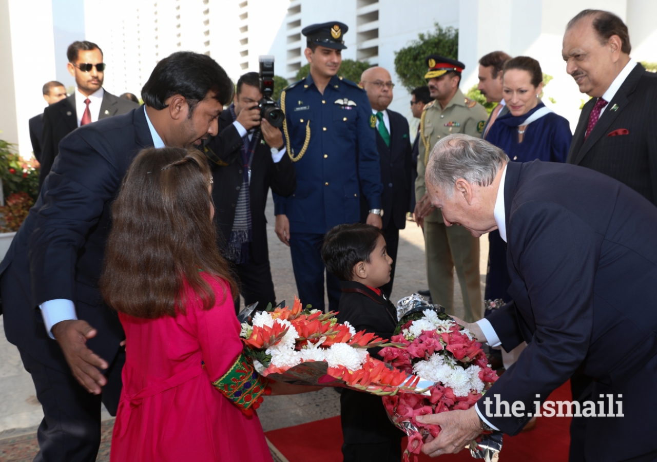 Mawlana Hazar Imam receives a bouquet of flowers upon arrival at the Aiwan-e-Sadr 