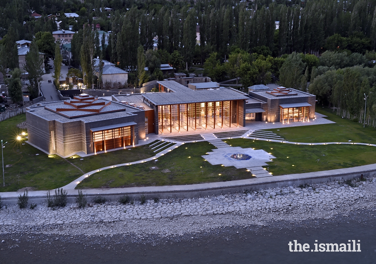 An evening view of the civic plaza, highlighting the radiant glow of the Ismaili Jamatkhana and Centre, Khorog.