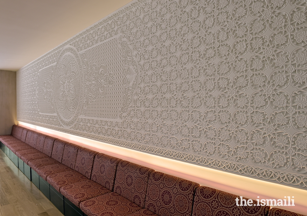 A carved plaster wall is the focal point of the multipurpose room at the Ismaili Jamatkhana and Centre, Khorog.
