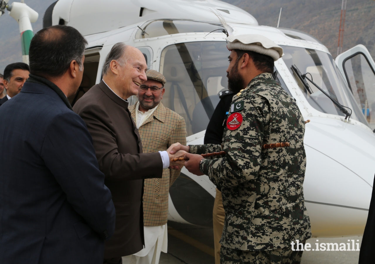 Mawlana Hazar Imam is greeted by Colonel Moinuddin, Commandant Chitral Scouts, upon his arrival at the Chitral Town Airport