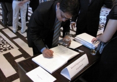 His Excellency Amar Sinha, Ambassador of India, signs the guest book at the Imamat Day Reception.