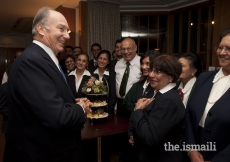 Mawlana Hazar Imam stops to speak with volunteers at a tea party for Prince Charles’ visit commemorating the 25th anniversary of the Ismaili Centre, London, 18 November 2010.