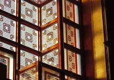An interior close-up view of the windows, which are decorated with stained geometric patterns.