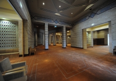 A view from the foyer towards the Prayer Hall Anteroom. Brick patterns and the calligraphy crowning the walls are among the prominent textures that characterise this space.