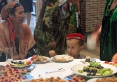 A little boy feasts his eyes on a delicious table of Eid sweets at the Ismaili Centre, Dushanbe.