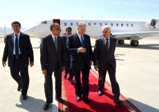 Mawlana Hazar Imam, His Excellency Hamrokhon Zarifi, Minister of Foreign Affairs and AKDN Resident Representative Munir Merali walk towards the VIP hall at Dushanbe International Airport.