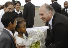 Mawlana Hazar Imam being presented with a bouquet of flowers upon arrival in Dar es Salaam.