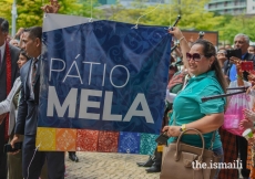 Jamati members and volunteers holding the Pátio Mela banner during the opening ceremonies of the Pátio Mela.