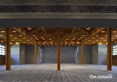 The prayer hall of the Ismaili Jamatkhana and Centre, Khorog. The geometric Kufic script at the wall articulates the names of the Ahl al-Bayt, or House of the Prophet.