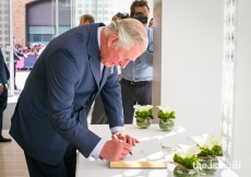 HRH The Prince of Wales signs the guest book at the Aga Khan Centre.
