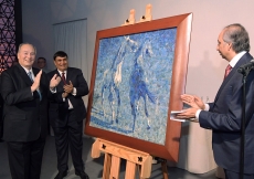 Mawlana Hazar Imam is presented with a birthday gift on behalf of the global Jamat. Titled “Horses”, this lapis lazuli mosaic was commissioned from the late Ismail Gulgee in 1989. Photo: Zahur Ramji