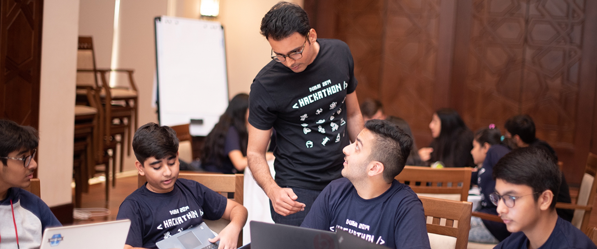 A Hackathon Dubai participant consults with a facilitator to determine if his group is on the right track.