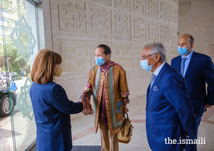 Princess Zahra welcomes Katerina Sakellaropoulou, President of Greece, to the Ismaili Centre, Lisbon, as Prince Hussain and Nazim Ahmad look on.