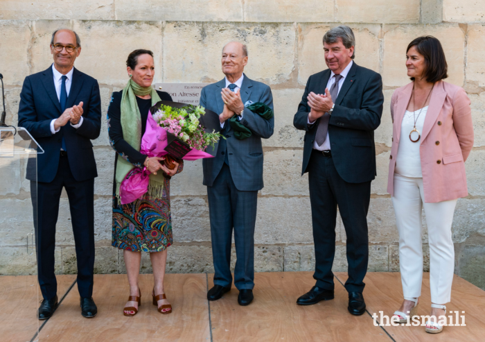 Princess Zahra joins Prince Amyn, Isabelle Wojtowiez, Xavier Darcos, and Eric Woerth on stage, and is presented with a bouquet of flowers to commemorate the special occasion.