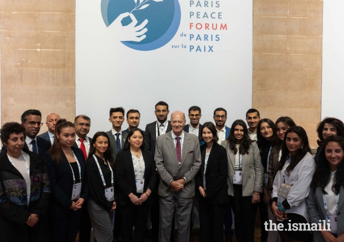 Prince Amyn at the Paris Peace Forum 2022 with volunteers from the community