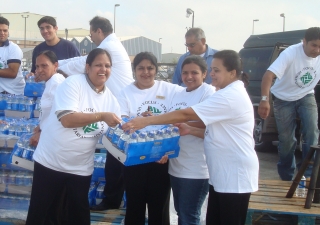 Volunteers from FOCUS Humanitarian Assistance unload water for people affected by Hurricane Ike at a Houston Point of Distribution. 