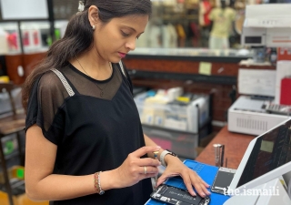 After taking a cell phone repair class, Malika Lirani now work at a repair shop in order to supplement her income.