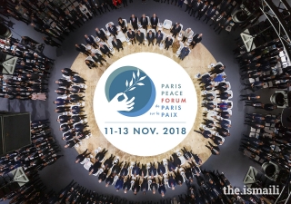 The official photograph of the participants at the opening session of the inaugural Paris Peace Forum.