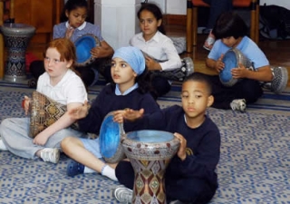 School children learn to play the daf, an Iranian percussion instrument.