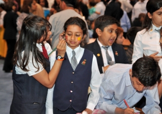 Youth volunteers take a moment to join in the fun and have their faces painted.
