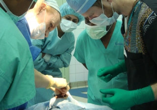 Medical professionals gather in a surgical theatre in Kinshasa to operate on a young patient. In addition to correcting patients’ facial deformities, Operation Smile gives local trainees a chance to learn from experts in their field.