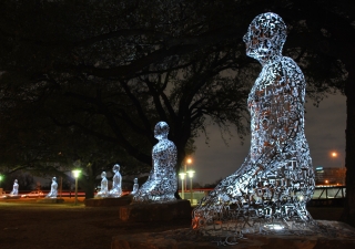 A view of the Tolerance sculptures along Allen Parkway at night time.