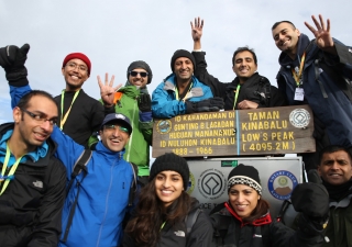 FOCUS Challenge4Life 2013 participants celebrate reaching the summit of Mount Kinabalu, before journeying on by foot, bicycle and raft to the South China Sea. Alnasir Jamal