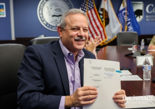 Director of CalOES, Mark Ghilarducci, showed the signed agreement to the other remote participants.