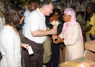 The Aga Khan is presented with a bouquet of dried flowers by Balbina Pinheiro. In the back, the Minister of Courtesy (Minister of Tourism), Mr Fernando Sumbana and the Director of the Entrepeneur Development Initiave, Eliane Damasceno looks on, 23 November 2007.