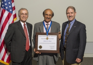 Alaudin Bhanji receiving NASA's Outstanding Leadership Award, in 2014. He is with the (then) Director of the Jet Propulsion Laboratory, Dr. Charles Elachi (L), and Dr. John M. Grunsfeld, Associate Administrator, Science Mission Directorate, NASA.