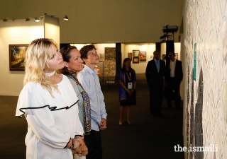 Princess Zahra, Miss Sara Boyden, and Master Iliyan Boyden view artwork at the International Art Gallery during the Diamond Jubilee Celebration.