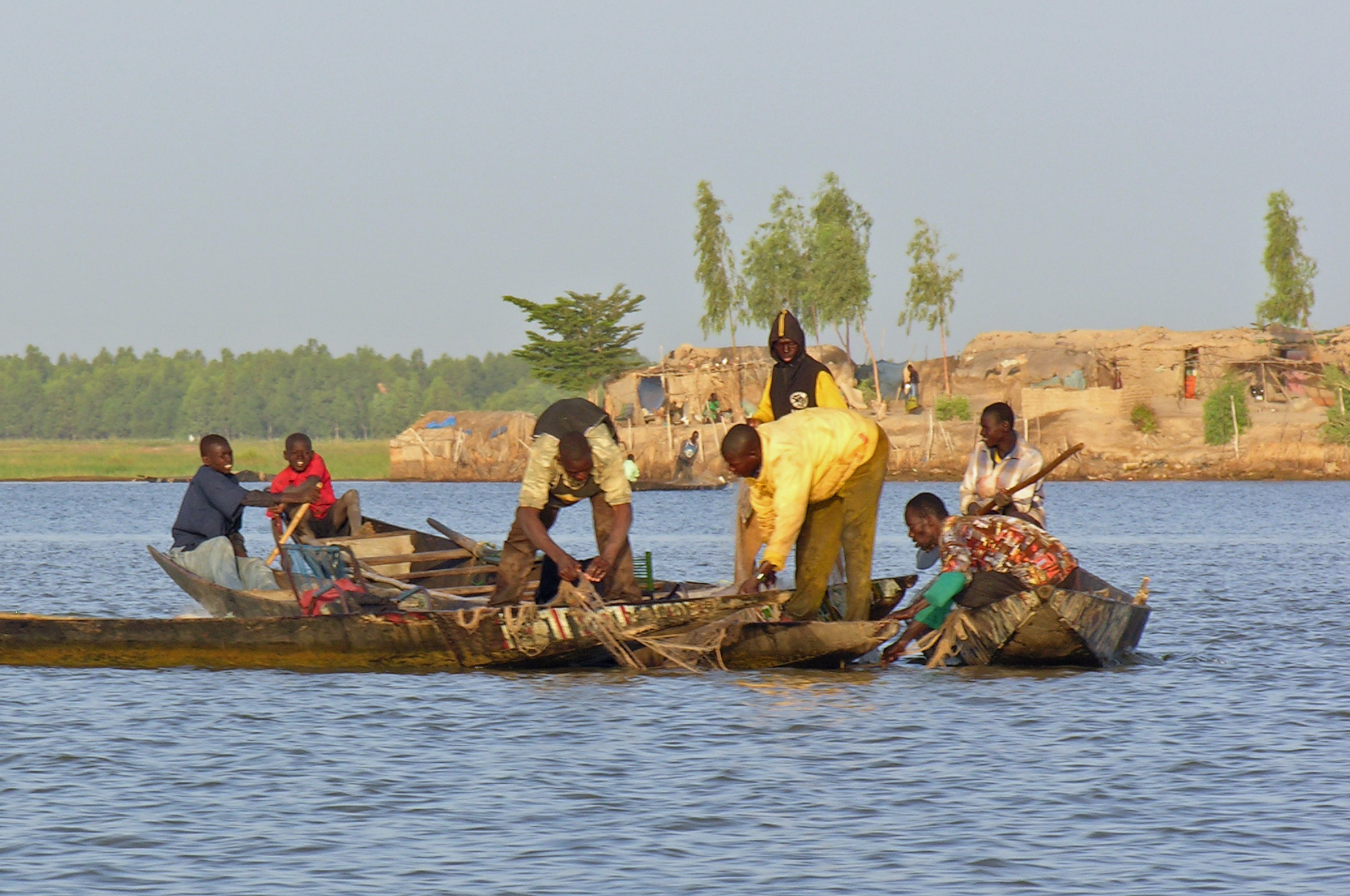 A group of fishermen on pirogues come together on the Niger River. The river and its tributaries are fished extensively, mainly for catfish and tilapia, which is then dried, smoked and consumed locally or exported to neighbouring countries. Photo: Courtesy of AKDN