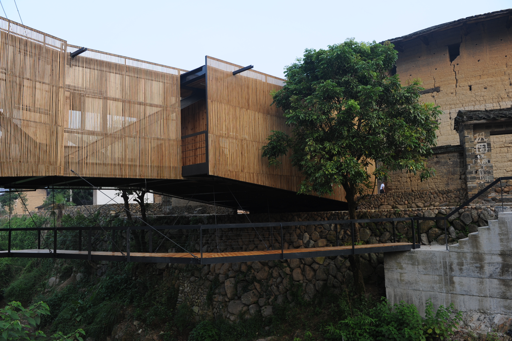 The Bridge School in the Fujian province of China connects two parts of a village separated by a river, and achieves unity in many other ways. Photo: Aga Khan Award for Architecture / Li Xiaodong